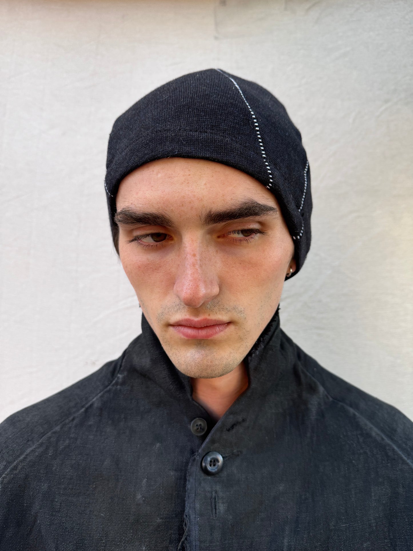 FW25 || TRIANGULAR PANEL BEANIE || OVERLOCKED || WHITE ON BLACK